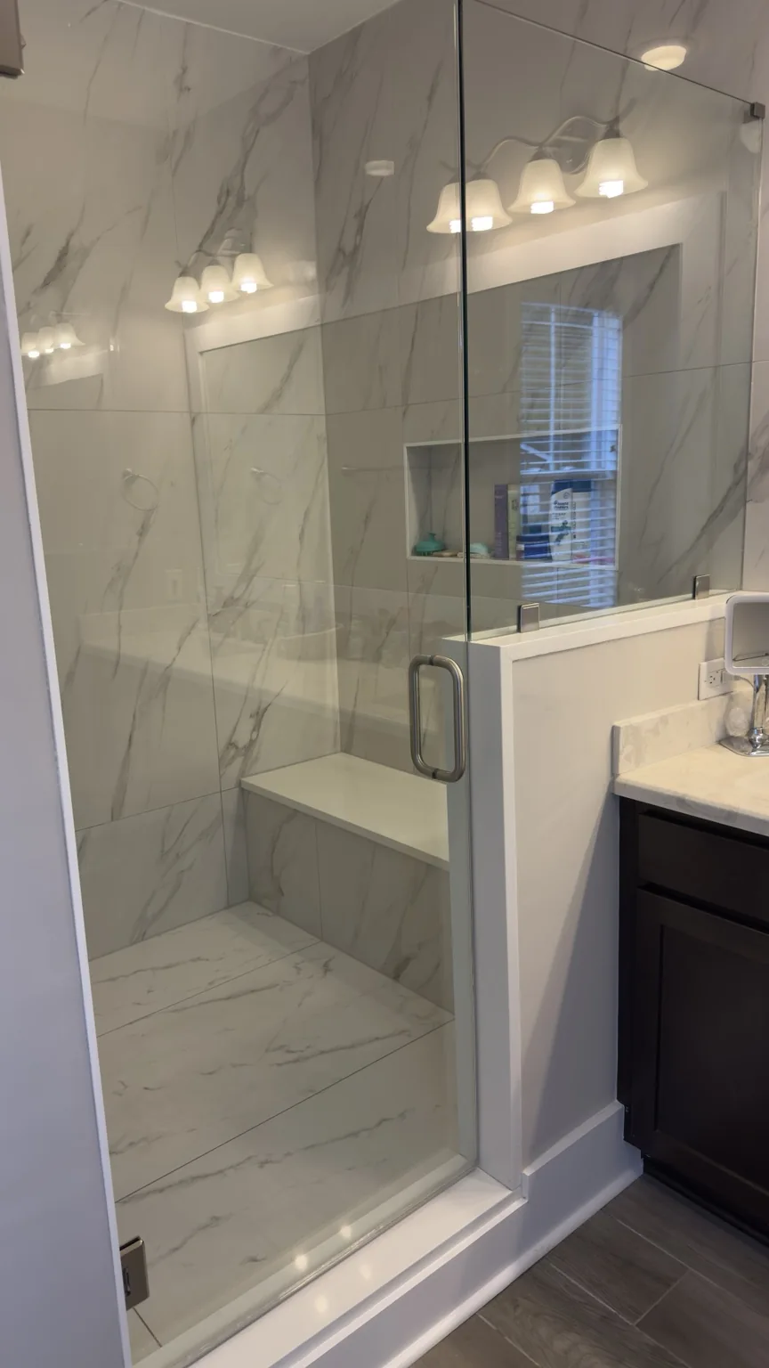 Clean glass shower with tile walls